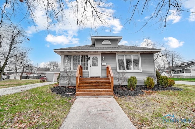 221 S Cherry St, Paulding, OH 45879 - bungalow-style home with driveway and a front lawn