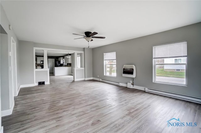 221 S Cherry St, Paulding, OH 45879 - unfurnished living room with ceiling fan, wood finished floors, heating unit, and visible vents