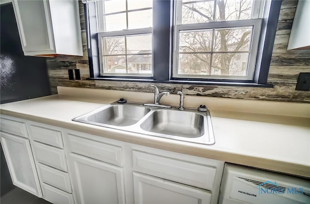 221 S Cherry St, Paulding, OH 45879 - kitchen with light countertops, dishwashing machine, white cabinetry, and a sink