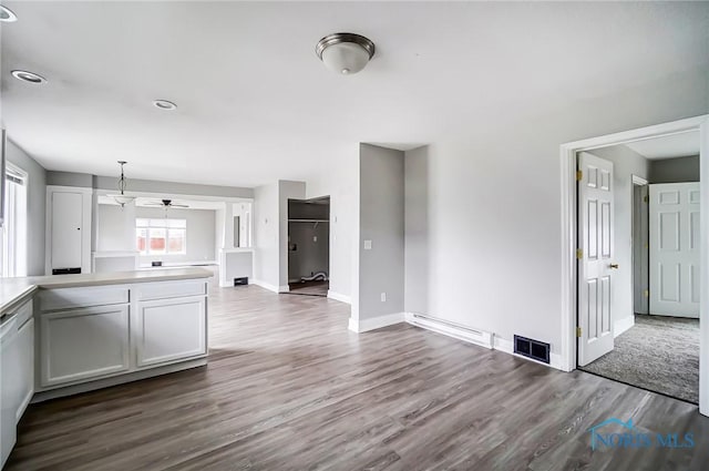 221 S Cherry St, Paulding, OH 45879 - kitchen featuring light countertops, visible vents, pendant lighting, baseboards, and dark wood-style flooring