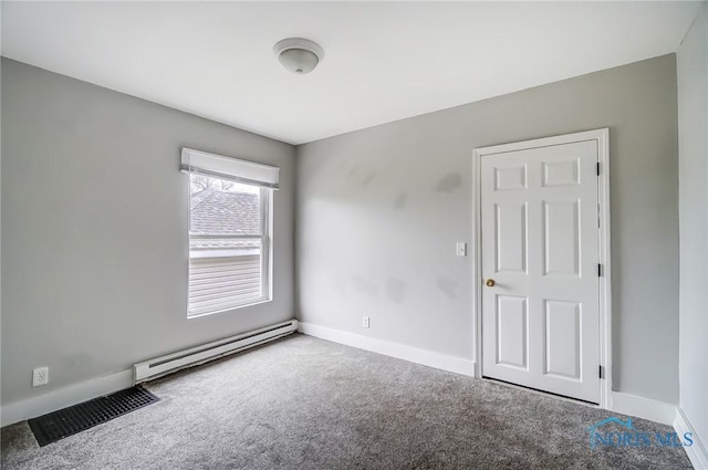 221 S Cherry St, Paulding, OH 45879 - carpeted spare room with a baseboard heating unit, visible vents, and baseboards