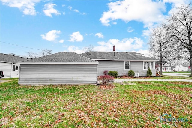 221 S Cherry St, Paulding, OH 45879 - back of house featuring a shingled roof and a yard