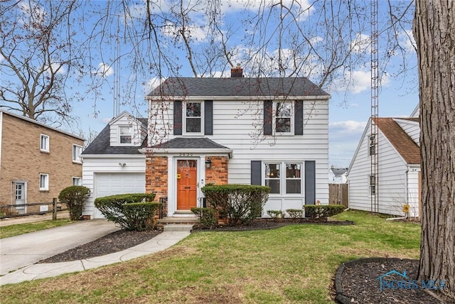 traditional-style home featuring roof with shingles, a chimney, concrete driveway, an attached garage, and a front yard