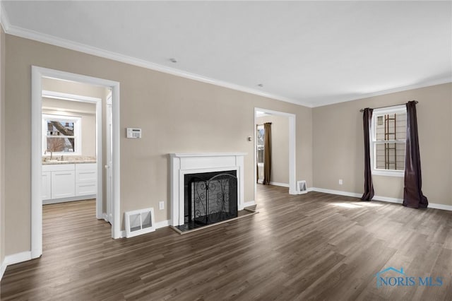 unfurnished living room with ornamental molding, dark wood-style flooring, and visible vents
