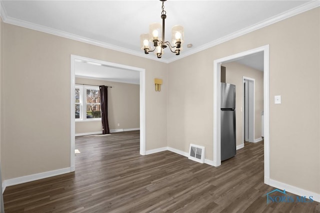 unfurnished dining area with baseboards, visible vents, a notable chandelier, and dark wood finished floors