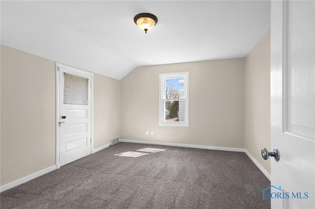 bonus room featuring lofted ceiling, visible vents, carpet flooring, and baseboards