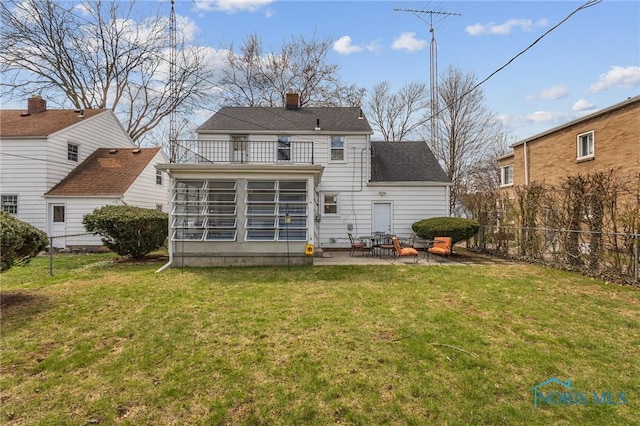 rear view of property with a patio area, a chimney, a fenced backyard, and a balcony