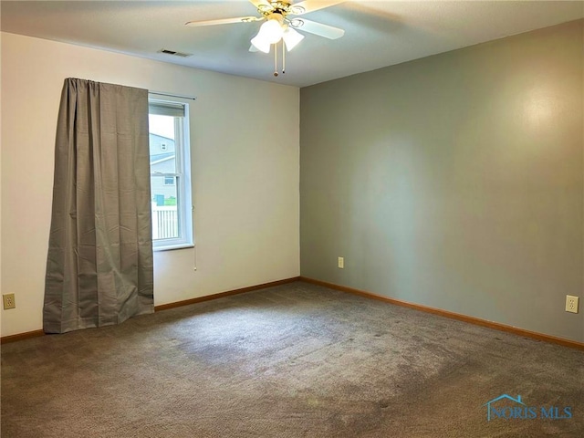 empty room featuring baseboards, a ceiling fan, carpet flooring, and visible vents