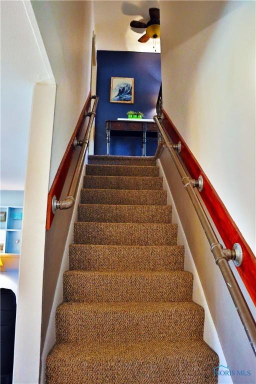 stairs with a ceiling fan