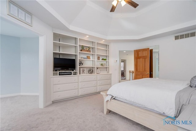 bedroom with a ceiling fan, a tray ceiling, light colored carpet, visible vents, and recessed lighting