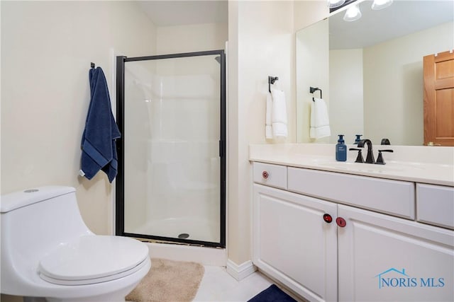 bathroom with toilet, vanity, tile patterned floors, and a stall shower