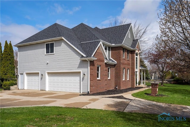 exterior space featuring roof with shingles, driveway, brick siding, a front yard, and a garage