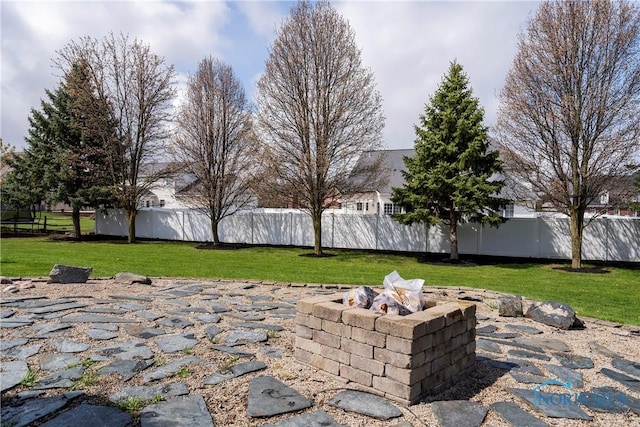 view of patio with an outdoor fire pit and fence