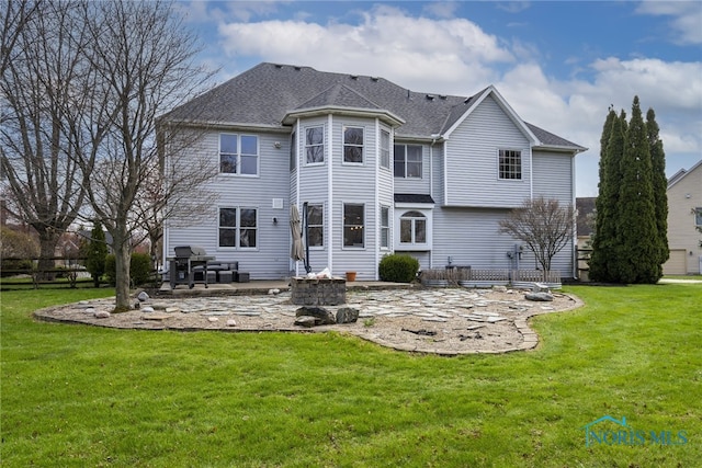 back of house featuring a lawn and a patio