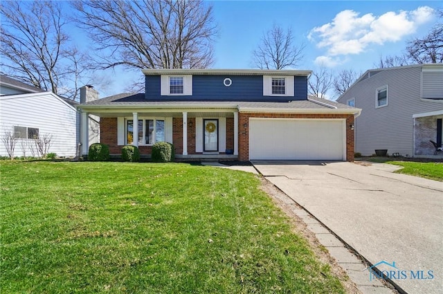 traditional-style house featuring brick siding, covered porch, a front yard, and concrete driveway