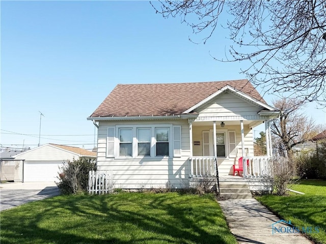 440 Union Ct, Fostoria, OH 44830 - bungalow with an outdoor structure, a porch, roof with shingles, a front yard, and a garage