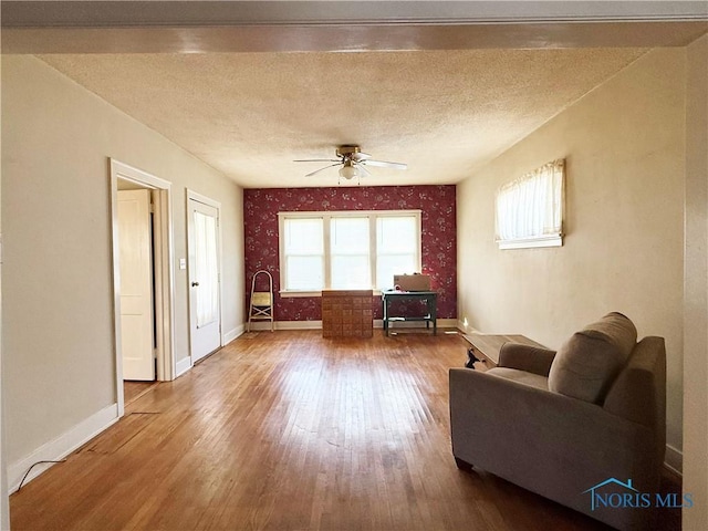 440 Union Ct, Fostoria, OH 44830 - living area with baseboards, a ceiling fan, wood finished floors, and a textured ceiling