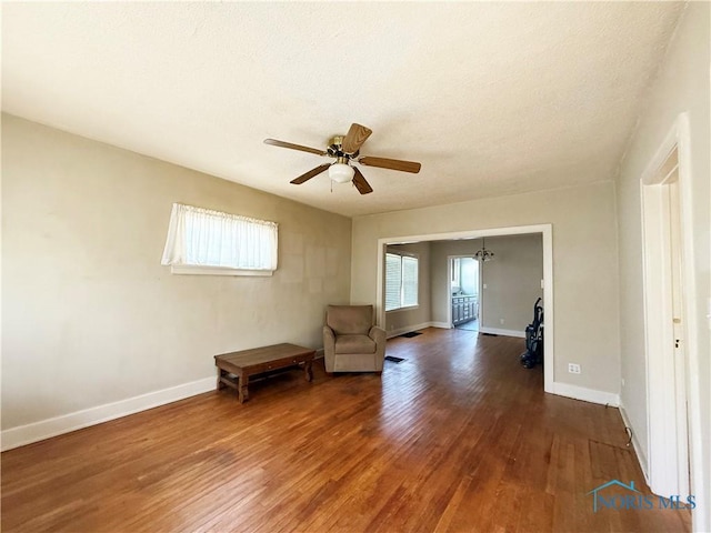 440 Union Ct, Fostoria, OH 44830 - living area with wood finished floors, a textured ceiling, baseboards, and ceiling fan