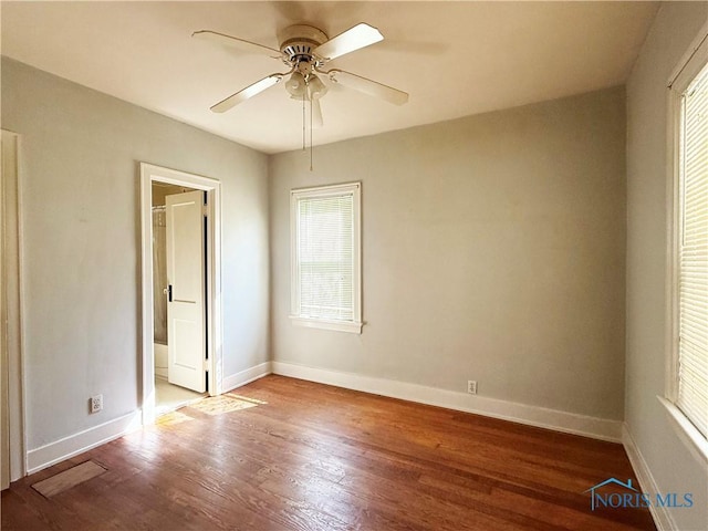 440 Union Ct, Fostoria, OH 44830 - unfurnished bedroom with baseboards, ensuite bathroom, wood finished floors, and ceiling fan