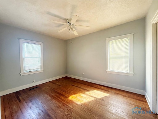 440 Union Ct, Fostoria, OH 44830 - spare room with hardwood / wood-style floors, baseboards, visible vents, and ceiling fan