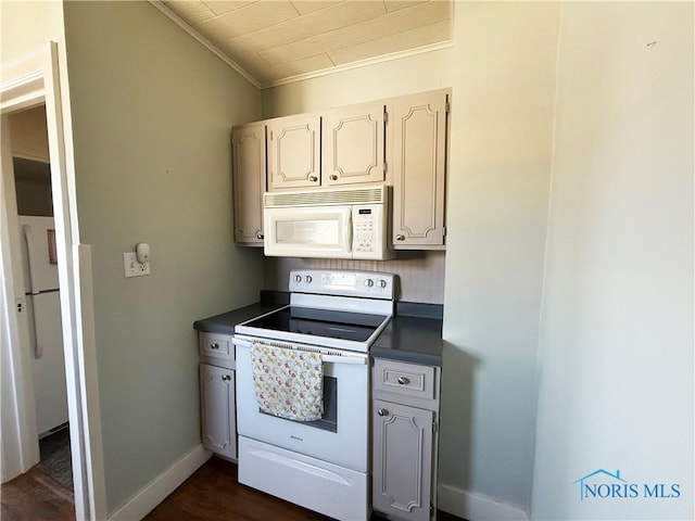 440 Union Ct, Fostoria, OH 44830 - kitchen with dark wood finished floors, dark countertops, white appliances, crown molding, and baseboards