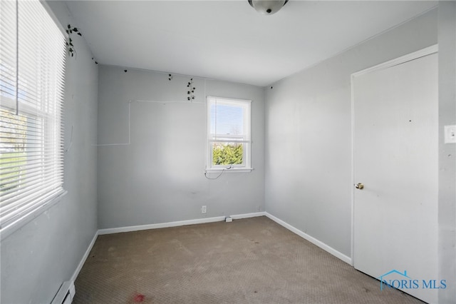402 S 5th St, Continental, OH 45831 - spare room with baseboards, carpet flooring, and a baseboard radiator