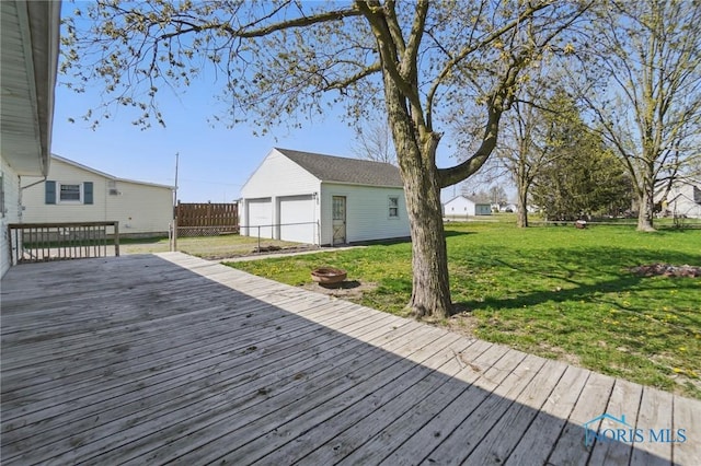 402 S 5th St, Continental, OH 45831 - deck with an outdoor structure, an outdoor fire pit, fence, a yard, and a garage