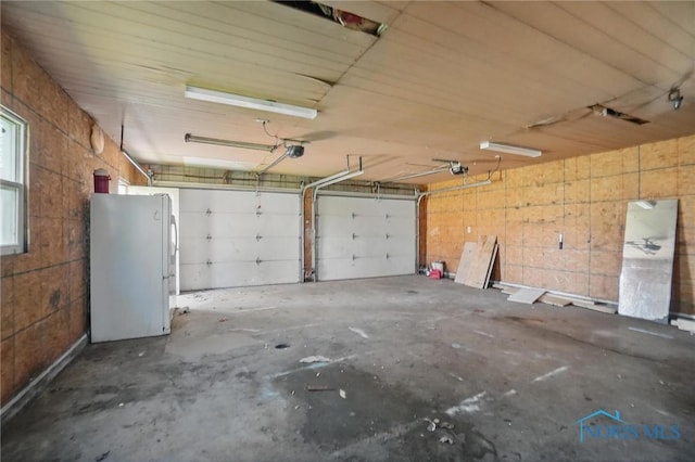 402 S 5th St, Continental, OH 45831 - garage featuring freestanding refrigerator and a garage door opener