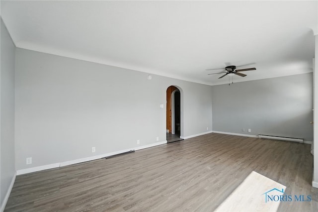 402 S 5th St, Continental, OH 45831 - unfurnished room with ceiling fan, a baseboard heating unit, baseboards, arched walkways, and wood finished floors