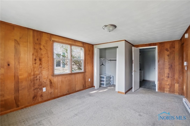 402 S 5th St, Continental, OH 45831 - unfurnished bedroom with carpet floors, a baseboard radiator, a closet, baseboards, and wooden walls