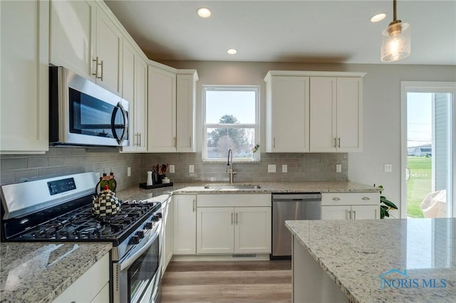 1007 Stoneleigh Rd, Perrysburg, OH 43551 - kitchen with a wealth of natural light, white cabinetry, stainless steel appliances, and a sink