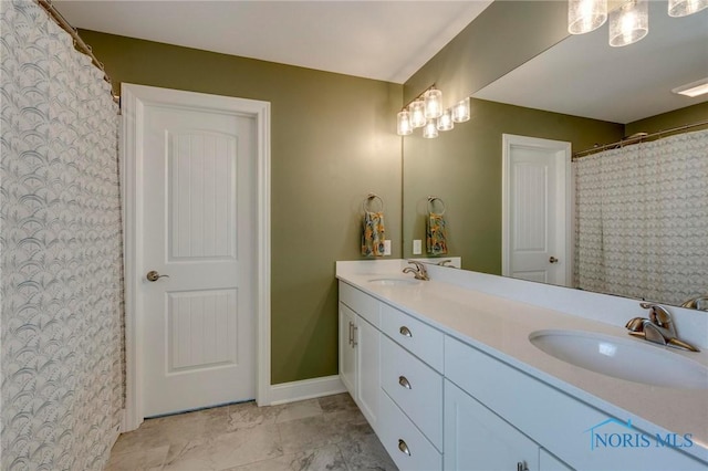 1007 Stoneleigh Rd, Perrysburg, OH 43551 - bathroom with double vanity, baseboards, and a sink