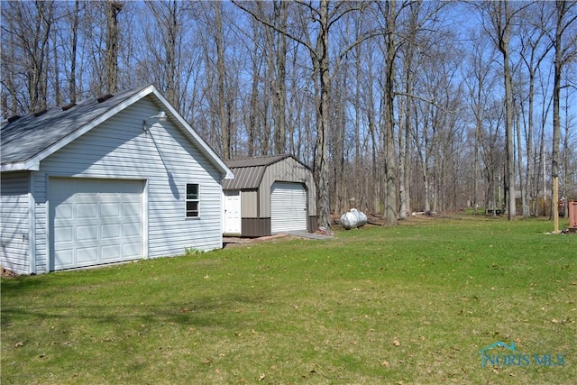 view of home's exterior with an outbuilding, a yard, and a garage
