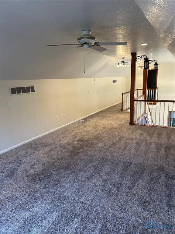 interior space with baseboards, visible vents, carpet floors, and ceiling fan