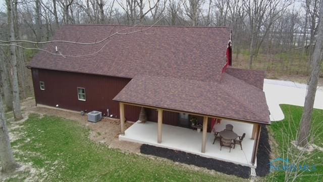 1673 Evan Dr, Defiance, OH 43512 - rear view of house with a patio, roof with shingles, a yard, and central air condition unit