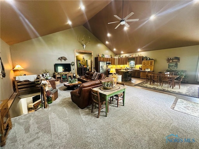 1673 Evan Dr, Defiance, OH 43512 - living room featuring light colored carpet, ceiling fan, and high vaulted ceiling
