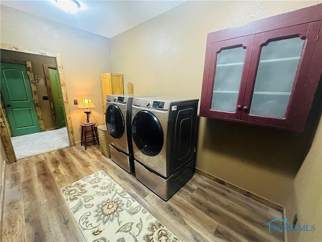 1673 Evan Dr, Defiance, OH 43512 - laundry area with cabinet space, separate washer and dryer, and light wood-style flooring