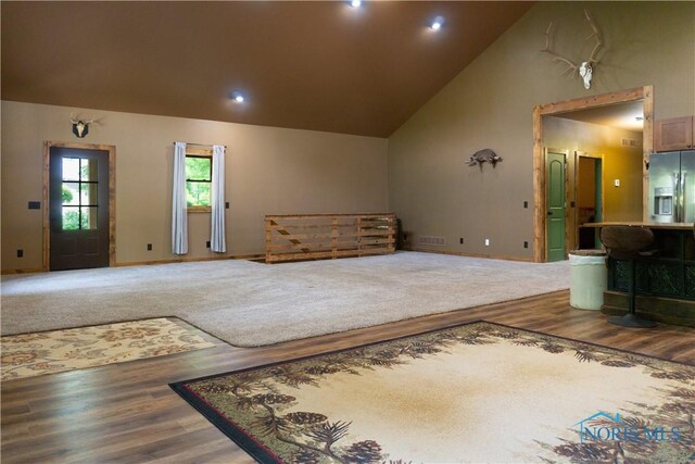 1673 Evan Dr, Defiance, OH 43512 - living area featuring wood finished floors, high vaulted ceiling, baseboards, and recessed lighting