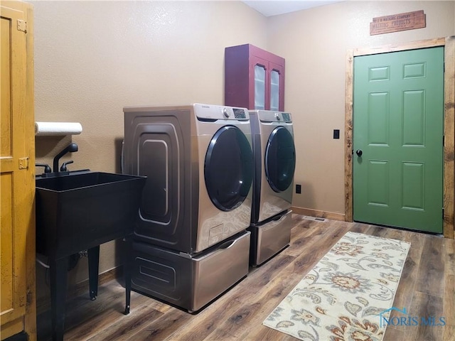 1673 Evan Dr, Defiance, OH 43512 - washroom with washing machine and clothes dryer and wood finished floors