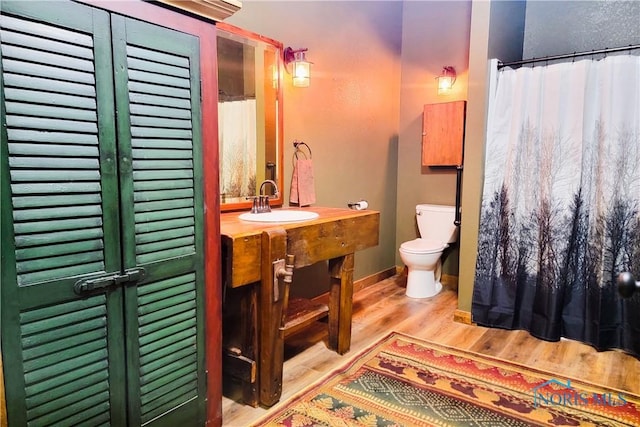 1673 Evan Dr, Defiance, OH 43512 - full bath with wood finished floors, vanity, and a shower with curtain
