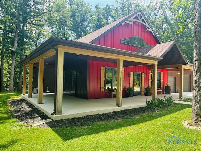 1673 Evan Dr, Defiance, OH 43512 - exterior space featuring board and batten siding, roof with shingles, and a yard
