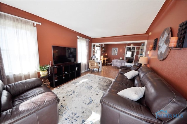 living room with plenty of natural light and wood finished floors