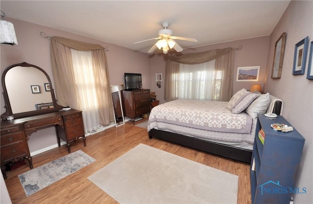 bedroom featuring wood finished floors and a ceiling fan