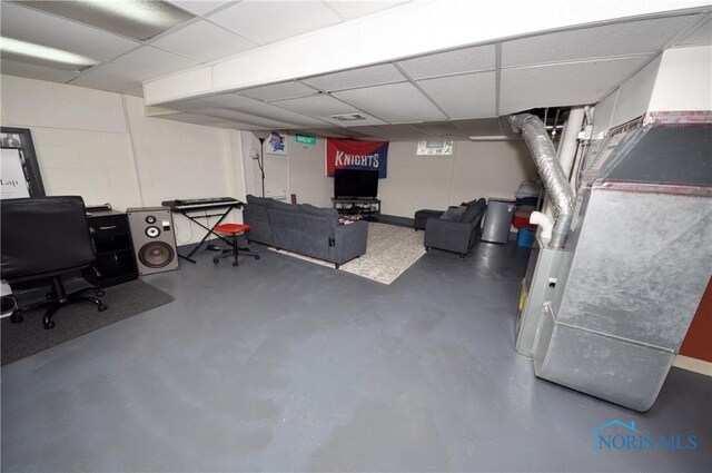 playroom featuring visible vents, finished concrete flooring, and a drop ceiling