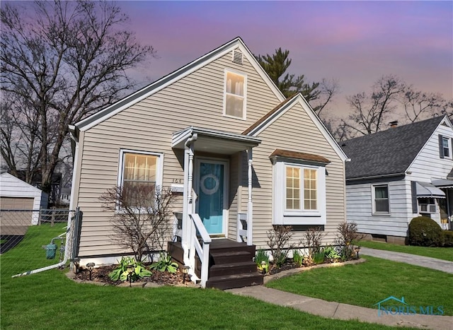 bungalow with a yard and fence