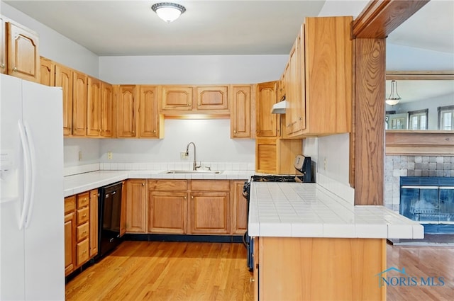 1000 Washington Ave, Findlay, OH 45840 - kitchen featuring white refrigerator with ice dispenser, black dishwasher, range with gas cooktop, under cabinet range hood, and a sink
