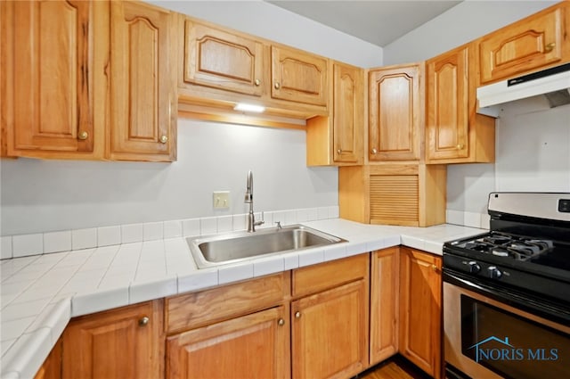 1000 Washington Ave, Findlay, OH 45840 - kitchen with stainless steel range with gas cooktop, a sink, under cabinet range hood, and tile countertops