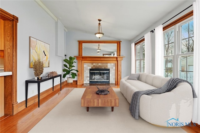 1000 Washington Ave, Findlay, OH 45840 - living area featuring vaulted ceiling, wood finished floors, and a tiled fireplace