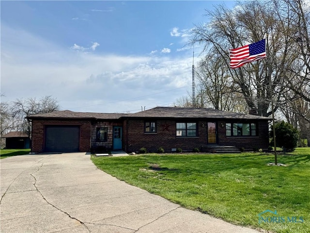 1965 Colwell Cir, Defiance, OH 43512 - single story home with concrete driveway, brick siding, a front yard, and a garage