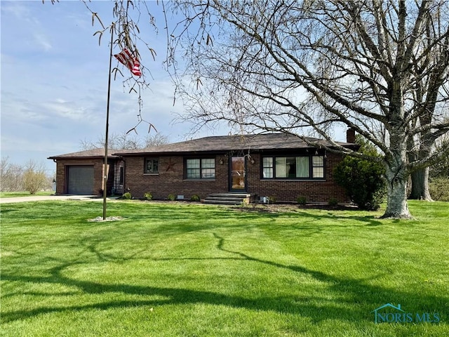 1965 Colwell Cir, Defiance, OH 43512 - single story home with a garage, a chimney, driveway, a front yard, and brick siding